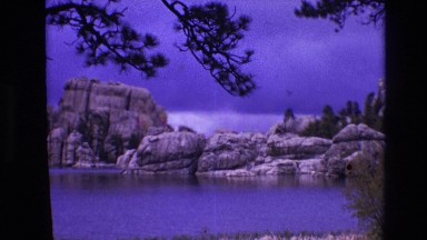 1974: scenic place with blue sparkling lake in the lap of mountain SOUTH DAKOTA