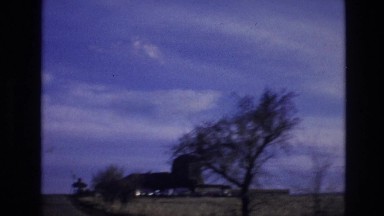 1974: wind farm on the top of hill with a grass land and some small trees VAIL