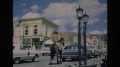 1969: man riding a horse into town as transportation. COLORADO SPRINGS COLORADO