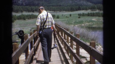 1966: a man walking down a bridge over the water LAKE TAHOE NEVADA