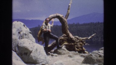 1966: a man standing before a nature view of a lake and trees LAKE TAHOE NEVADA