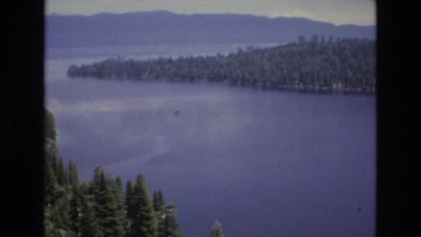 1966: a beautiful body of water surrounded by hills covered in pine trees