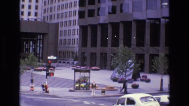 1968: view of bottom floors of urban buildings and the sidewalk and street