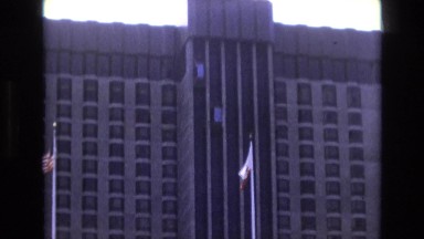 1968: huge building hotel flag hoisted cars moving