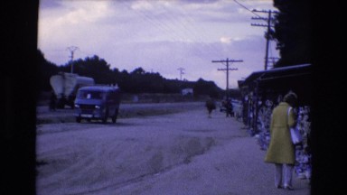 1969: Snow Covered Area with Trucks and Cars Passing by Spain