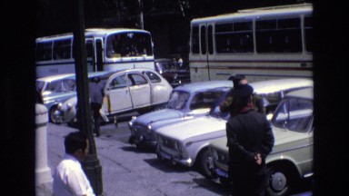 1969: people standing around, waiting on their ride. SPAIN