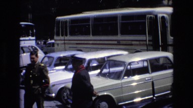 1969: Open Area with Cars Parked and a Huge Bus in Spain