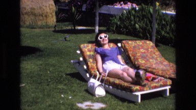 1969: A Woman Wearing White Sunglasses Lounging in the Sun in Spain