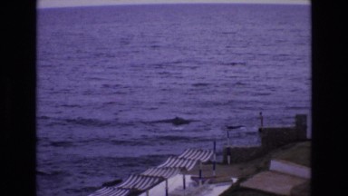 1969: sea view people walking tents around waves shore landmarks