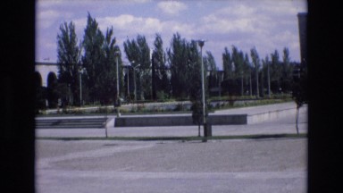 1969: community square in foreground as cars pass by SPAIN