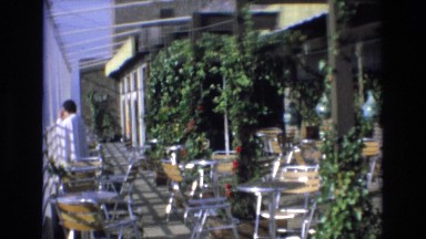 1969: tourism vintage clip, seats and tables of outdoor restaurant