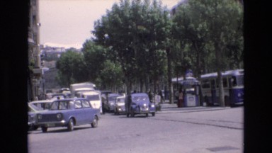 1969: view of cars and buses traveling down a busy street