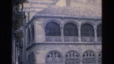 1969: people walking down below an important building. SPAIN