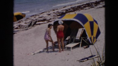 1956: tent like beach scene woman talking CUBA