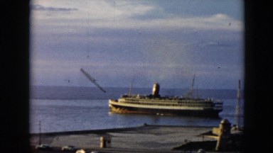 1956: a beautiful cruise liner in the water pulling away from the coast CUBA
