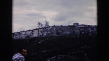 1956: people viewing a distant area standing on a fence CUBA