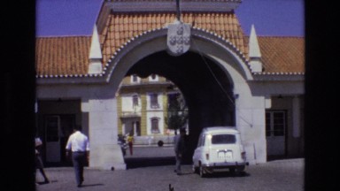 1972: Car Drives Through Checkpoint on Busy Street in Portugal