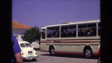 1972: A Parked Bus Beside a Blue Punch Buggy Car in Portugal