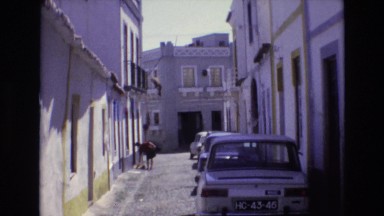1972: cars parked alongside trees pathway PORTUGAL