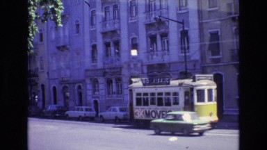 1972: tram moving through the city beside the apartments on either side PORTUGAL