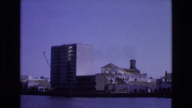 1972: Skyscrapers of a City Under the Clear Blue Sky on the Shore of Lake