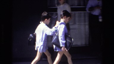1972: a boy pushing another boy outside on a sidewalk SPAIN