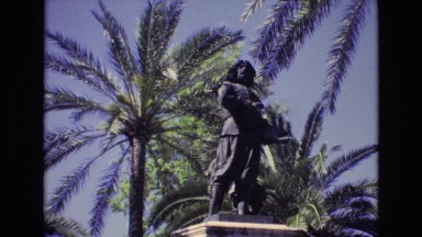 1972: A Beautiful Sightseeing Statue in a Park by a Scenery of Palm Trees