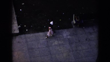 1956: view from top couple walking together pathway people sitting alongside