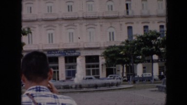 1956: hotel like building in a open area busy street CUBA