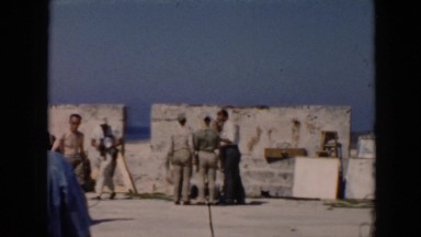 1956: people moving around in a tourism area dressed up CUBA
