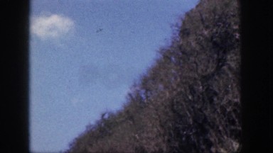 1961: Road Through Hilly Hawaiian Terrain with Cliffs and Dried Grasses