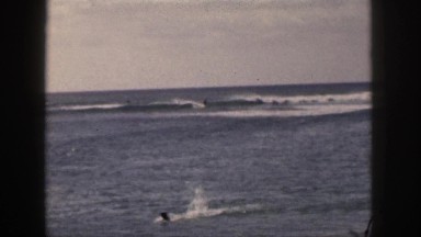 1961: various people swimming in the ocean near the beach HAWAII