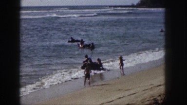 1961: children playing near seaside waves coming pushing having fun
