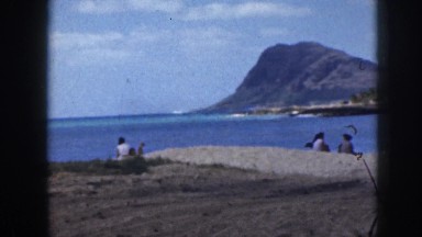 1961: people play on scenic beach with crashing waves during sunny day HAWAII