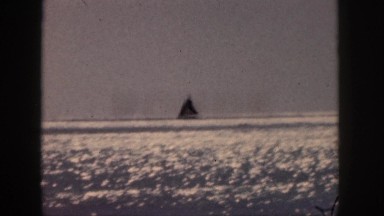 1961: sunshine upon the lake; sailboat off in the distance. HAWAII