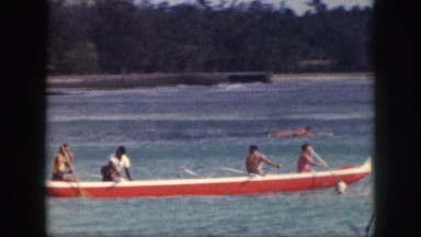 1961: members holiday rowing boat free time at beach in the evening happily