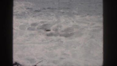 1961: ocean waves crashing on a rocky beach on a beautiful day HAWAII
