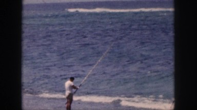 1961: man fishing at the beach HAWAII