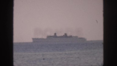 1961: ship sailing far off in the distant. HAWAII