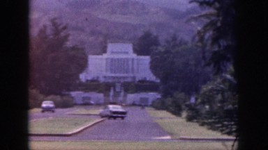 1961: in the lap of a mountain an elegant white painted house stands with road