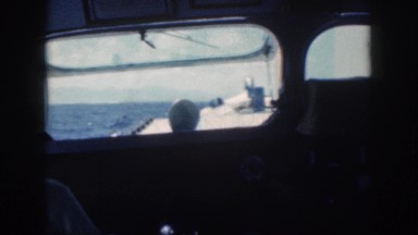 1961: man steering ship or boat while in the middle of the sea HAWAII