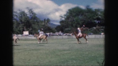 1961: men are playing hockey on the horseback in the grassy ground HAWAII