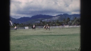 1961: riders compete in polo on horses while spectators watch them. HAWAII