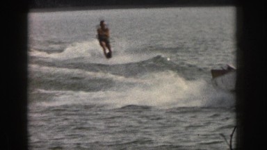 1961: seawater people surfing sailing boat enjoying having fun trees around