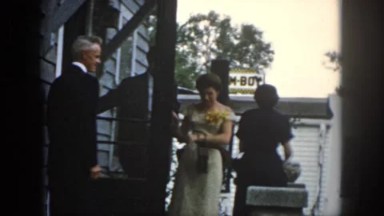1958: woman in corsage and gloves with husband in 50s ready for an event DAYTON