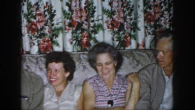 1958: two women and two men are tightly seated on a couch in a living room