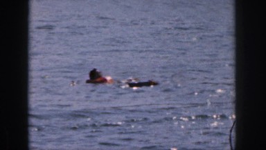 1961: swimmers wearing life jackets thrashing about and splashing