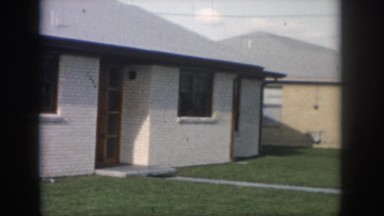 1958: a simple brick house with a garage and no landscaping NEW ORLEANS