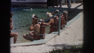 1958: Women and Men Sit Poolside Wearing Scuba Gear Awaiting Instruction