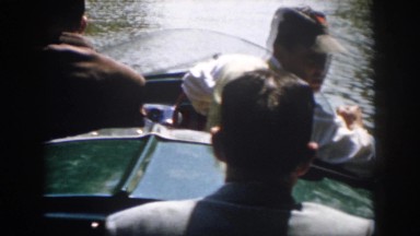 1958: a small motorboat with four passengers speeds down the river VIRGINIA